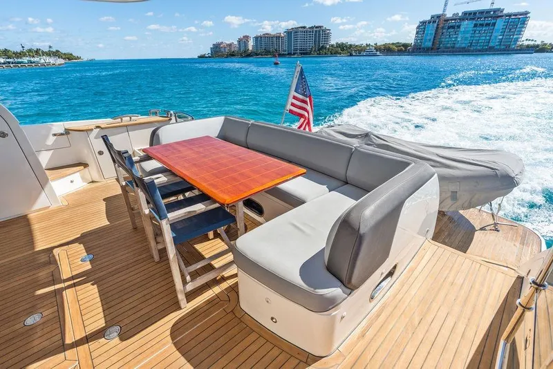 Slide: The Image of 2016 Princess 60 Flybridge Motor Yacht deck with seating, table, and ocean view. - 35