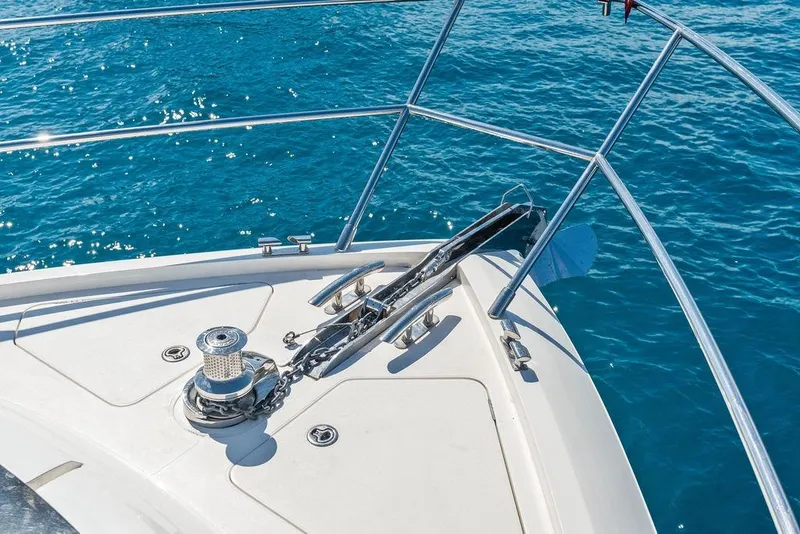Slide: The Image of Bow of 2016 Princess 60 Flybridge Motor Yacht with anchor, on clear blue water. - 58