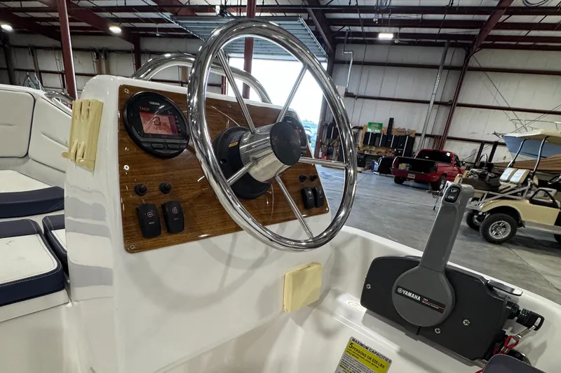 Slide: The Image of 2018 AB Inflatables Nautilus 12 DLX boat steering console in a warehouse setting. - 12