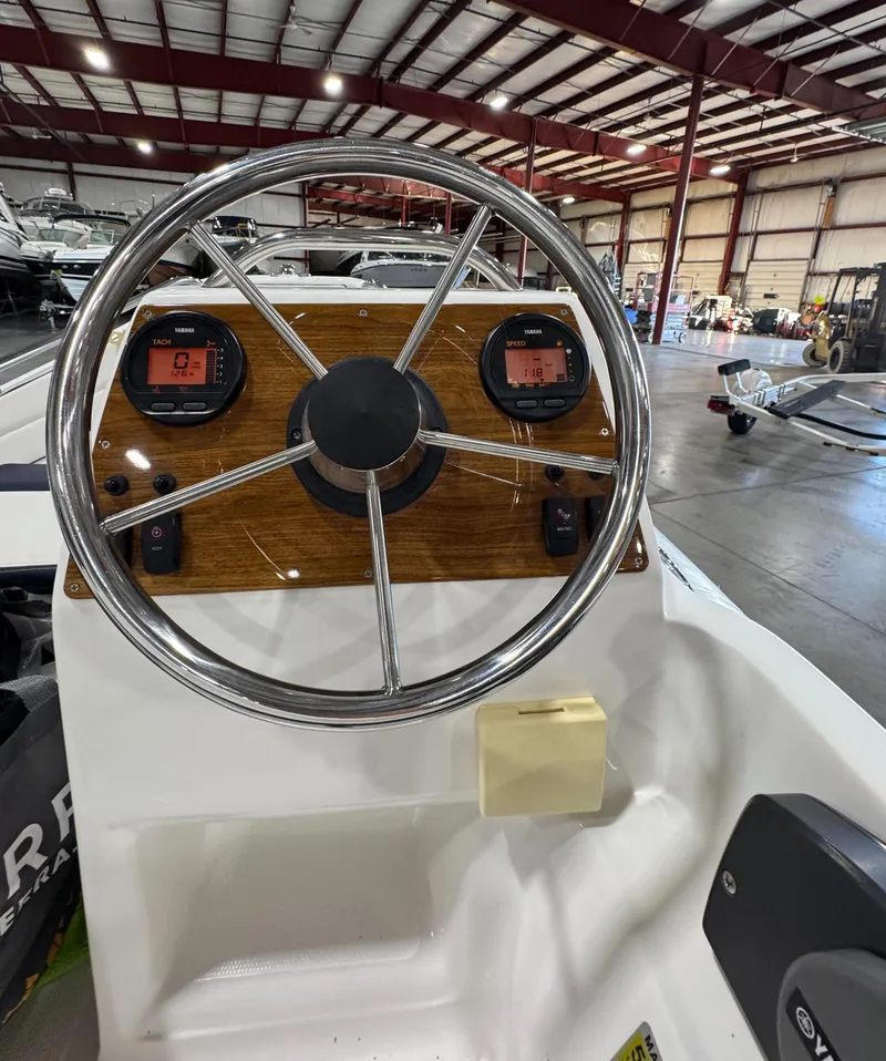Slide: The Image of 2018 AB Inflatables Nautilus 12 DLX steering wheel and dashboard in a showroom. - 13