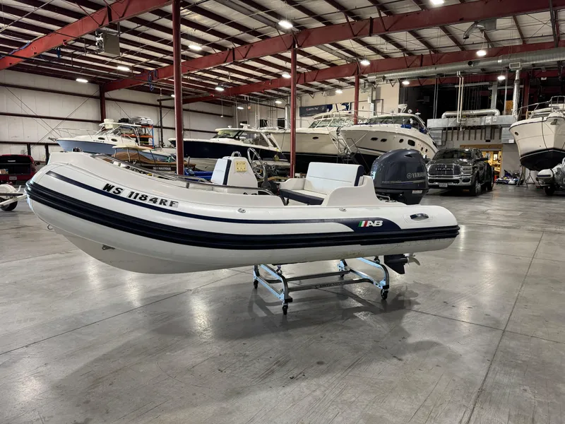 Slide: The Image of 2018 AB Inflatables Nautilus 12 DLX boat in a showroom with other vessels. - 2
