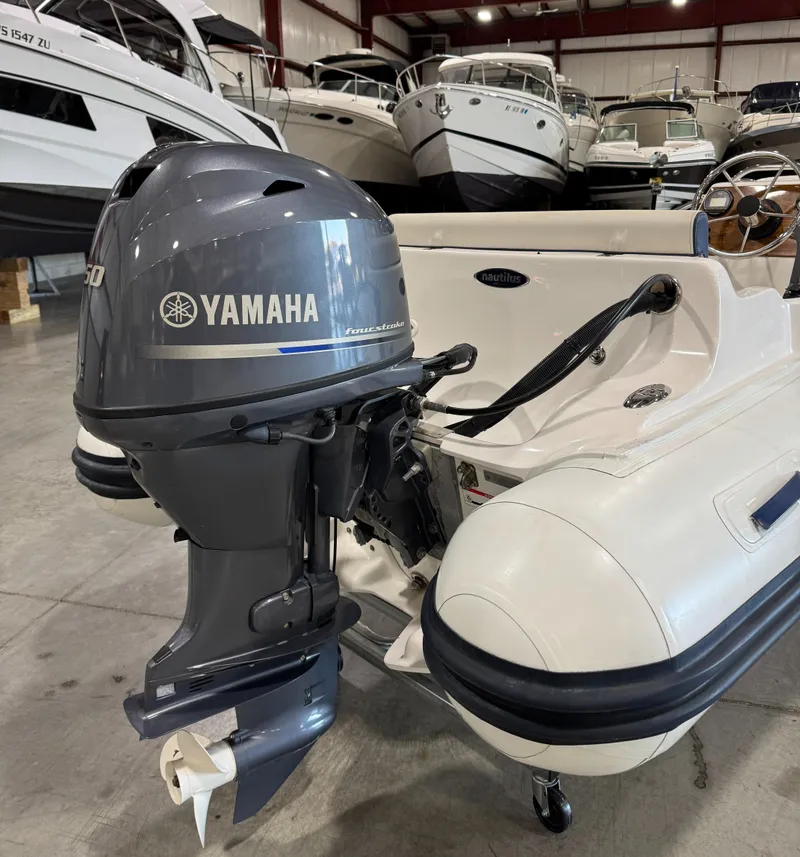 Slide: The Image of 2018 AB Inflatables Nautilus 12 DLX with Yamaha outboard motor in a boat showroom. - 5