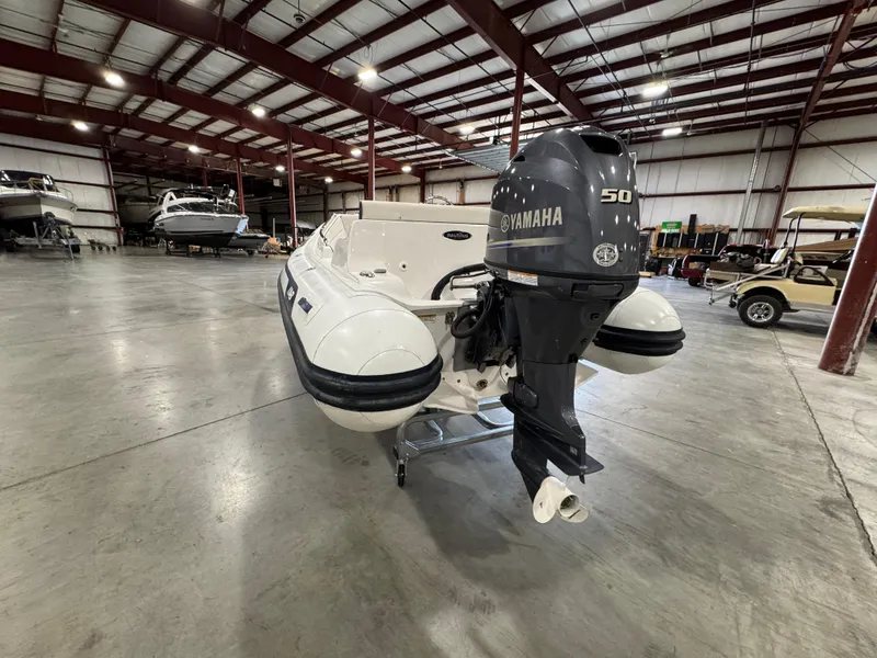 Slide: The Image of 2018 AB Inflatables Nautilus 12 DLX with Yamaha 50 engine in a spacious warehouse. - 7