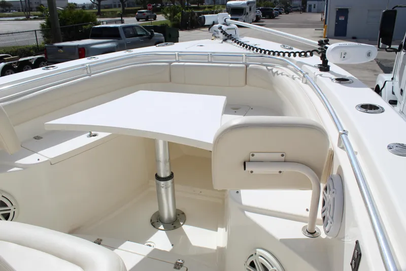 Slide: The Image of 2019 Cobia 301 Center Console boat with seating and table in the bow area. - 10