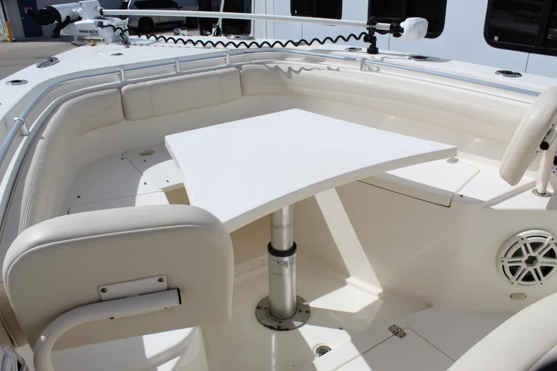 Slide: The Image of 2019 Cobia 301 Center Console boat interior with seating and table setup. - 11