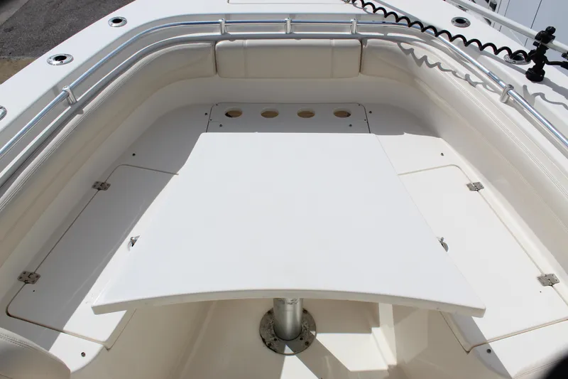Slide: The Image of 2019 Cobia 301 Center Console boat deck with seating and storage compartments. - 12
