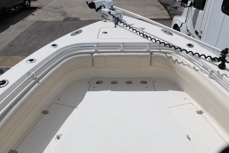 Slide: The Image of 2019 Cobia 301 Center Console boat deck with railings and storage compartments. - 13