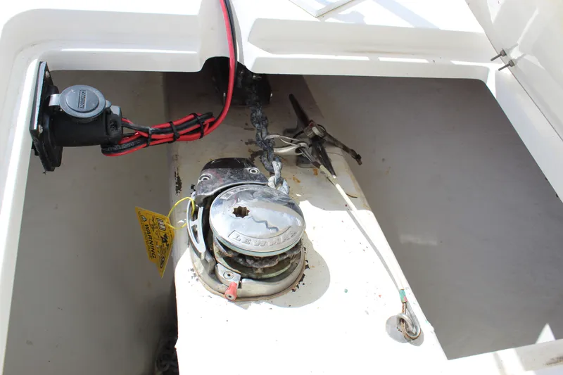 Slide: The Image of 2019 Cobia 301 Center Console anchor compartment with wiring and winch. - 15