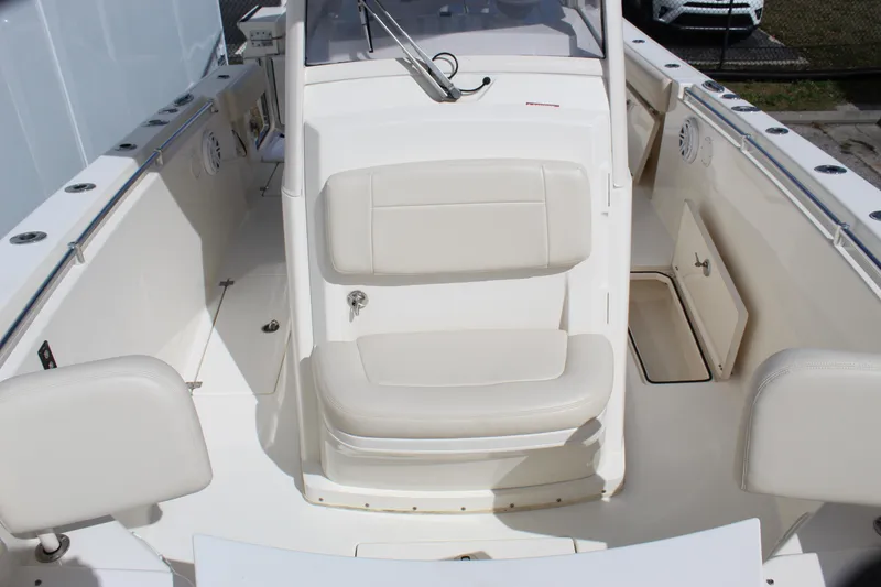 Slide: The Image of 2019 Cobia 301 Center Console boat interior with white seating and console. - 16