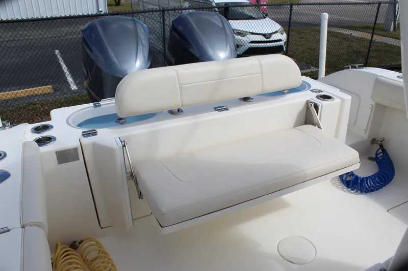 Slide: The Image of 2019 Cobia 301 Center Console boat interior with seating and dual outboard motors. - 18