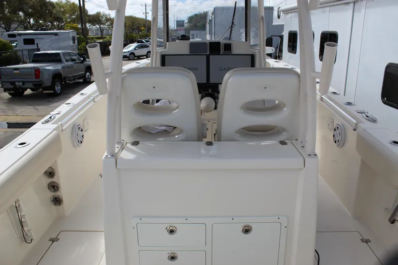 Slide: The Image of 2019 Cobia 301 Center Console boat interior with dual seats and Garmin navigation system. - 19