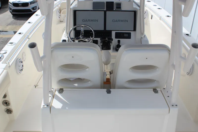 Slide: The Image of 2019 Cobia 301 Center Console boat cockpit with dual Garmin displays and steering wheel. - 23