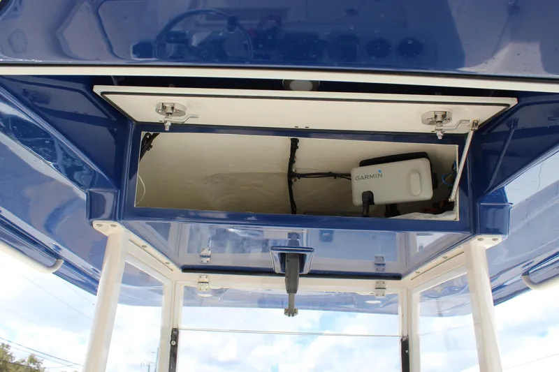 Slide: The Image of 2019 Cobia 301 Center Console boat with Garmin equipment storage compartment. - 31