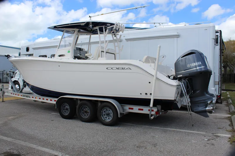 Slide: The Image of 2019 Cobia 301 Center Console boat on trailer with Yamaha outboard motor. - 5