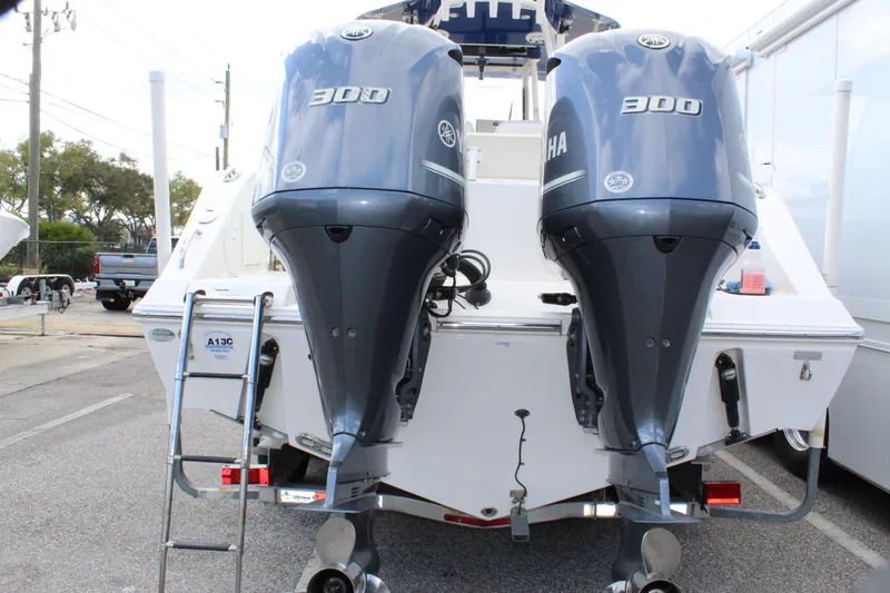 Slide: The Image of 2019 Cobia 301 Center Console with dual Yamaha 300 engines, rear view. - 9