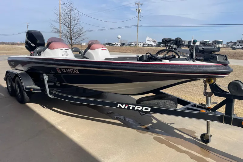 Slide: The Image of 2008 Nitro NX 898 DC boat on trailer, parked outdoors, featuring Mercury engine. - 2