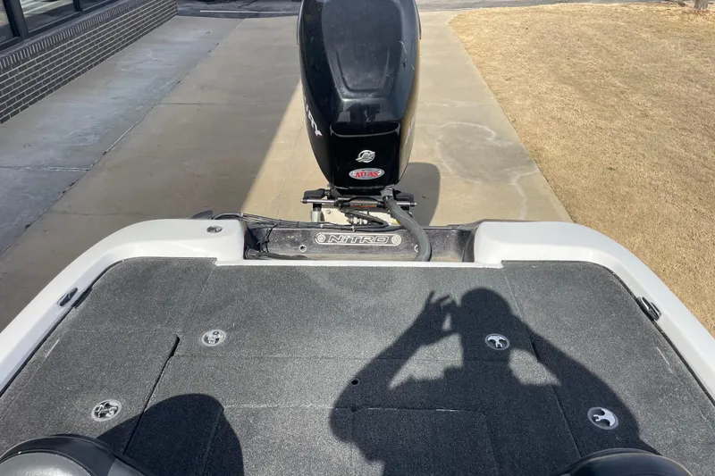 Slide: The Image of 2008 Nitro NX 898 DC boat with motor, shadow on deck, outdoor setting. - 5