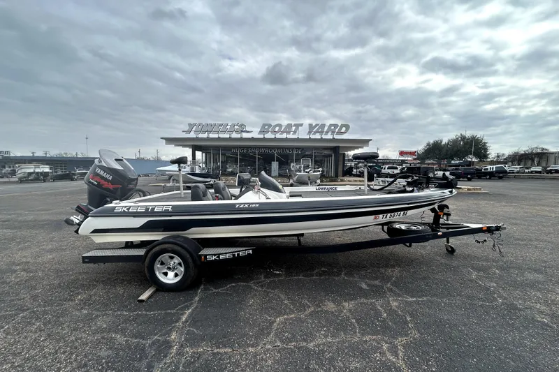 The Image of 2014 Skeeter TZX195 boat on trailer at dealership, overcast sky. - 0