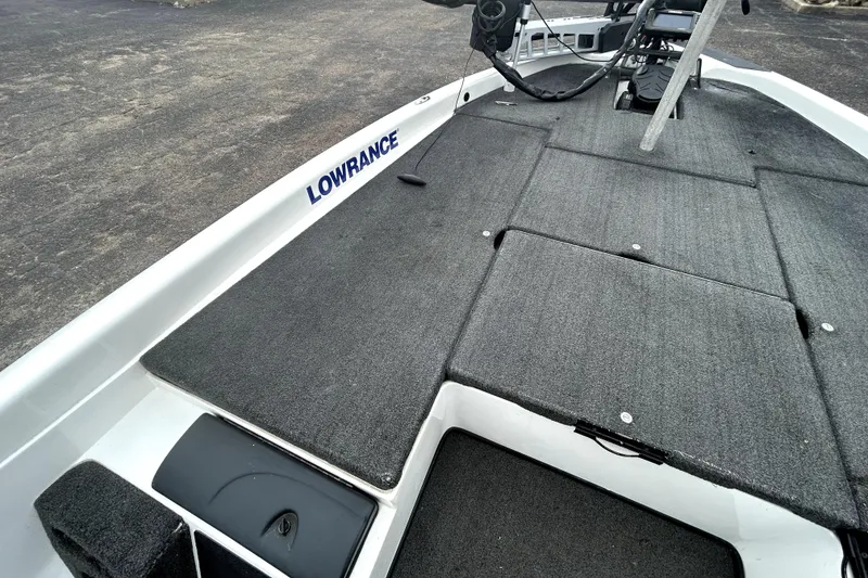 Slide: The Image of 2014 Skeeter TZX195 boat deck with Lowrance equipment, featuring gray carpeted surface. - 10