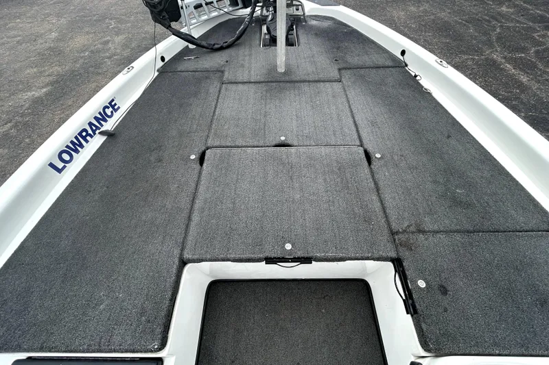 Slide: The Image of 2014 Skeeter TZX195 boat deck with Lowrance equipment, featuring gray carpeting. - 12