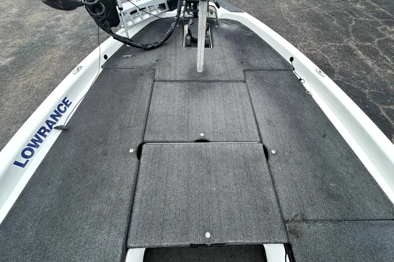 Slide: The Image of 2014 Skeeter TZX195 boat deck with Lowrance equipment, featuring a spacious, carpeted layout. - 14