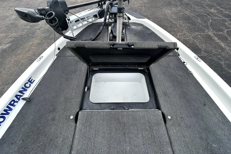 Slide: The Image of 2014 Skeeter TZX195 boat with open storage compartment and trolling motor. - 15