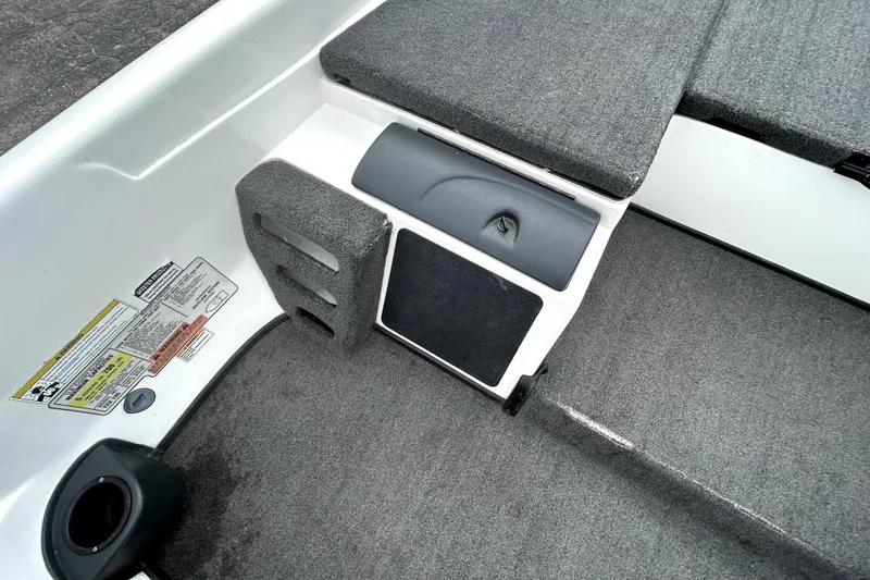 Slide: The Image of 2014 Skeeter TZX195 boat interior with gray carpet and storage compartments. - 20