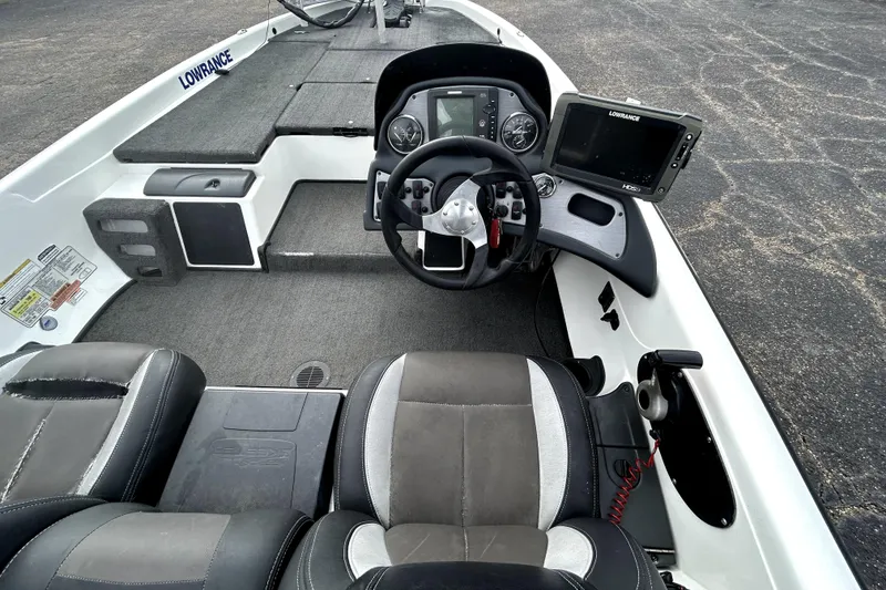 Slide: The Image of Interior of a 2014 Skeeter TZX195 boat with steering wheel and navigation system. - 23