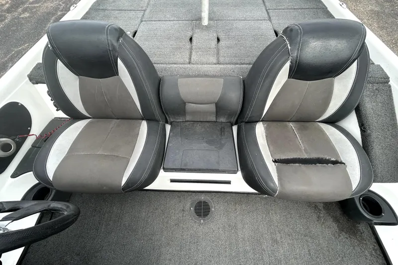 Slide: The Image of 2014 Skeeter TZX195 boat seats with gray and black upholstery, showing wear and tear. - 25