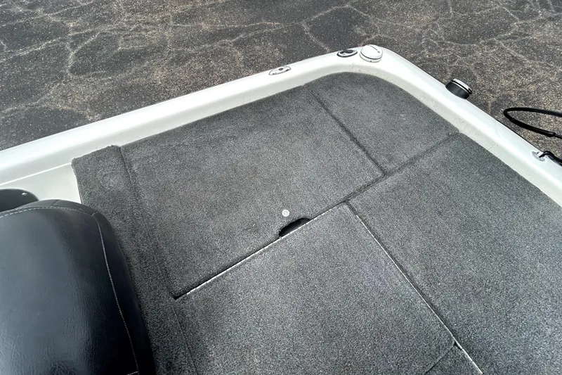 Slide: The Image of 2014 Skeeter TZX195 boat deck with gray carpet and black seat. - 28