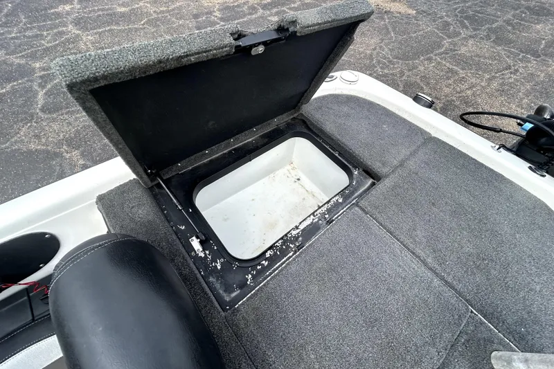 Slide: The Image of Open storage compartment on 2014 Skeeter TZX195 boat, featuring carpeted interior. - 29