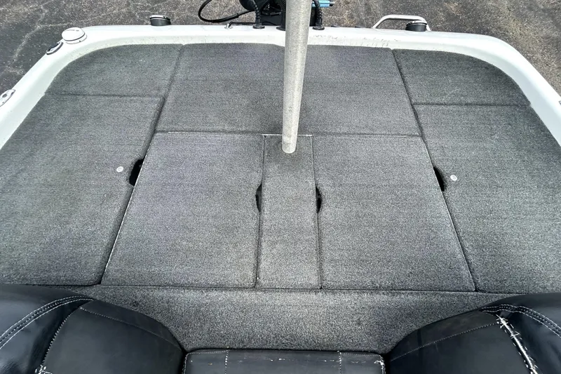 Slide: The Image of 2014 Skeeter TZX195 boat deck with gray carpet and storage compartments. - 30