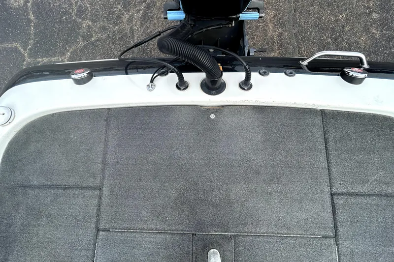 Slide: The Image of 2014 Skeeter TZX195 boat deck with carpeted surface and motor controls. - 34