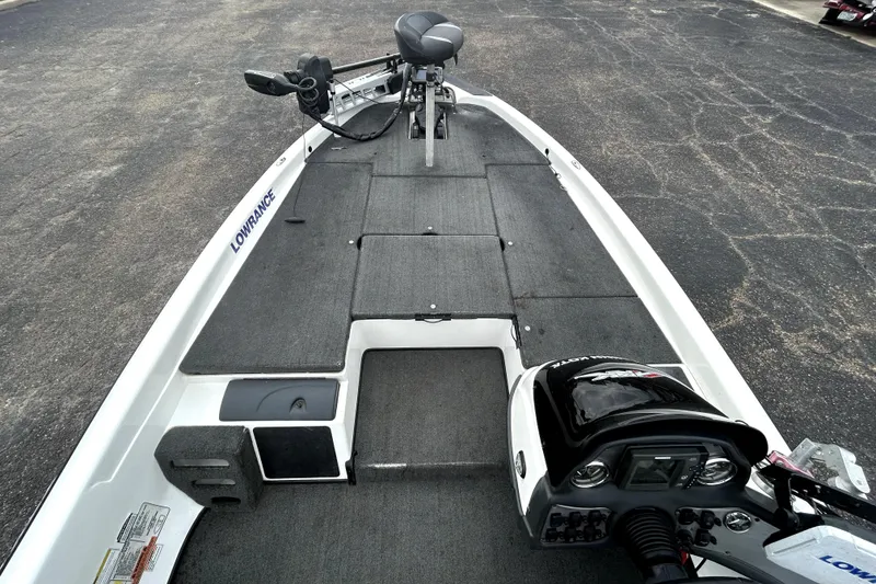 Slide: The Image of 2014 Skeeter TZX195 boat interior with Lowrance equipment, featuring a spacious deck and control panel. - 8