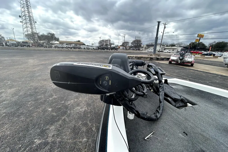 Slide: The Image of 2014 Skeeter TZX195 boat with trolling motor, parked outdoors under cloudy skies. - 9