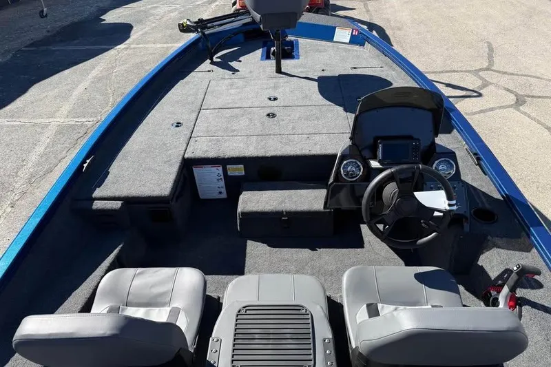 Slide: The Image of 2026 Lowe Stinger 175C boat interior with dual seats and steering console. - 10