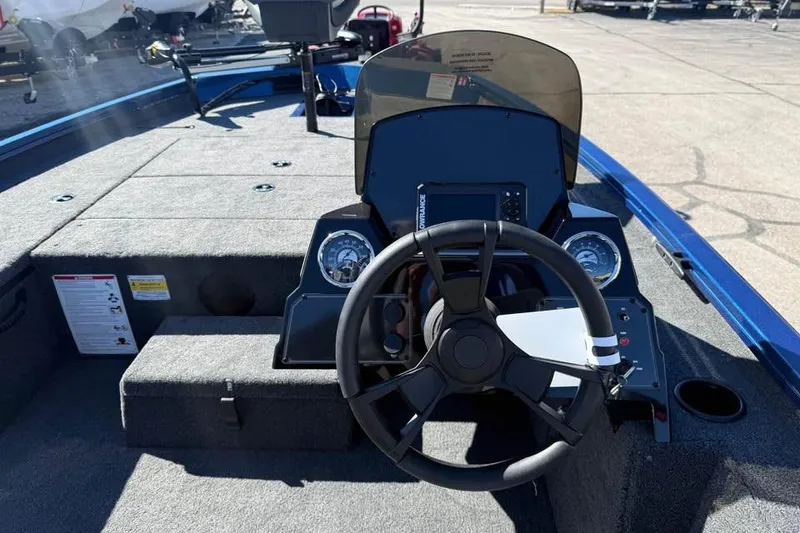 Slide: The Image of 2026 Lowe Stinger 175C boat interior with steering wheel and dashboard controls. - 12