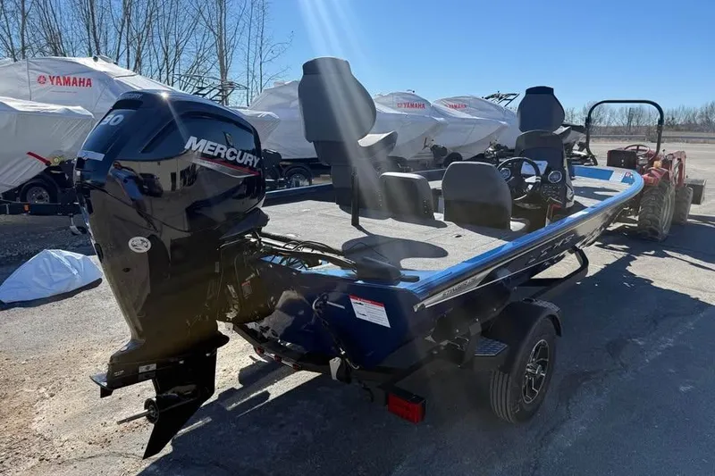 Slide: The Image of 2026 Lowe Stinger 175C boat with Mercury engine, parked outdoors on a sunny day. - 4