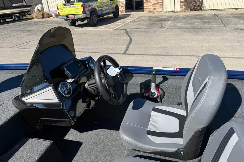 Slide: The Image of Interior of 2026 Lowe Stinger 175C boat with steering console and seat. - 8