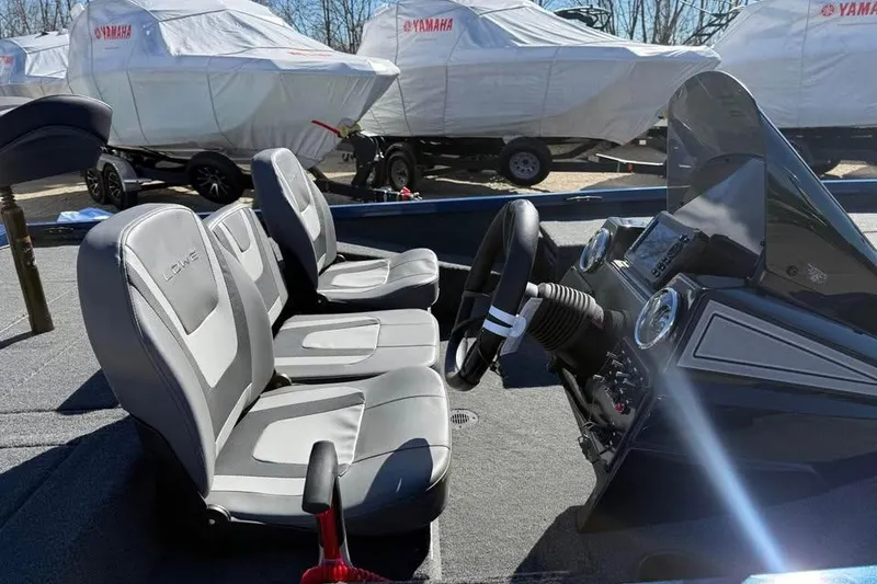 Slide: The Image of 2026 Lowe Stinger 175C boat interior with dual seats and steering console. - 9