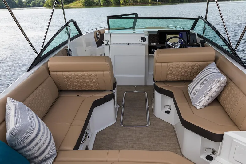 Slide: The Image of Manufacturer Provided Image: 2020 Sea Ray SDX 250 Outboard boat interior with tan seating and striped pillows. - 7