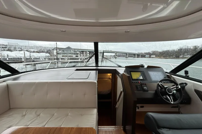 Slide: The Image of Interior view of 2016 Tiara Yachts C44 Coupe, featuring helm and seating area. - 11