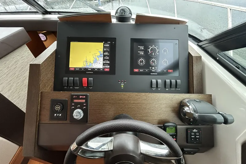 Slide: The Image of Cockpit of 2016 Tiara Yachts C44 Coupe with Garmin navigation displays and controls. - 13