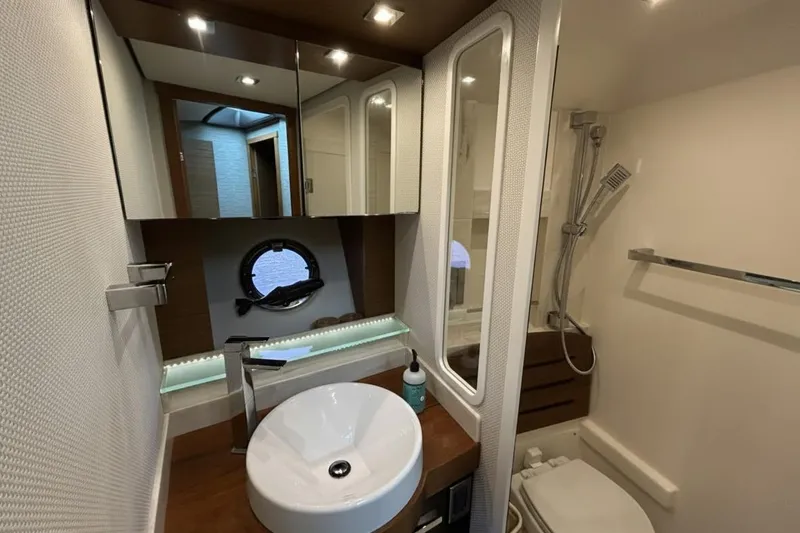 Slide: The Image of Luxurious bathroom in 2016 Tiara Yachts C44 Coupe with modern fixtures and porthole window. - 18