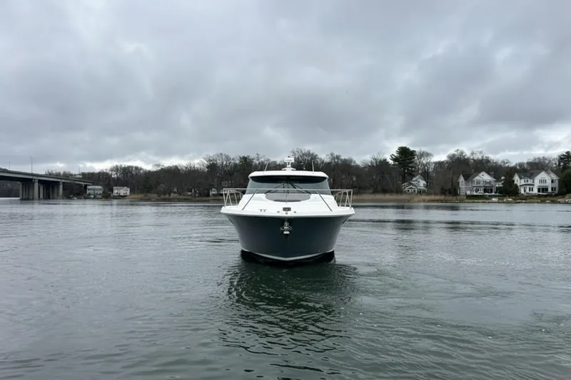 Slide: The Image of 2016 Tiara Yachts C44 Coupe on calm water under cloudy skies. - 2