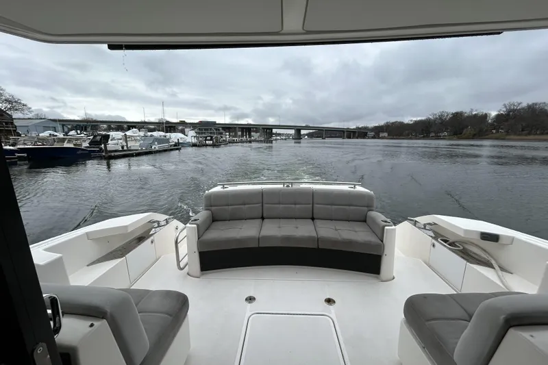 Slide: The Image of 2016 Tiara Yachts C44 Coupe interior with waterfront view and seating area. - 5