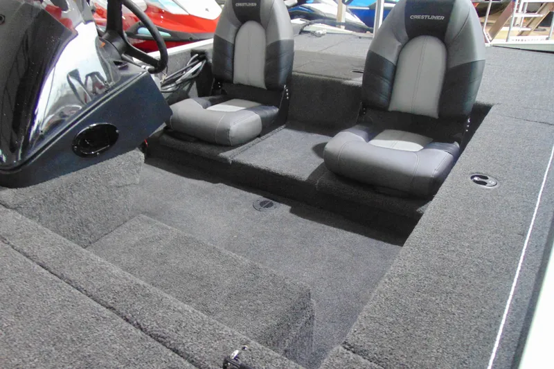 Slide: The Image of 2026 Crestliner 1600 Storm boat interior with dual seats and carpeted flooring. - 6