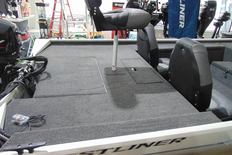Slide: The Image of 2026 Crestliner 1600 Storm boat interior with seating and carpeted deck. - 8