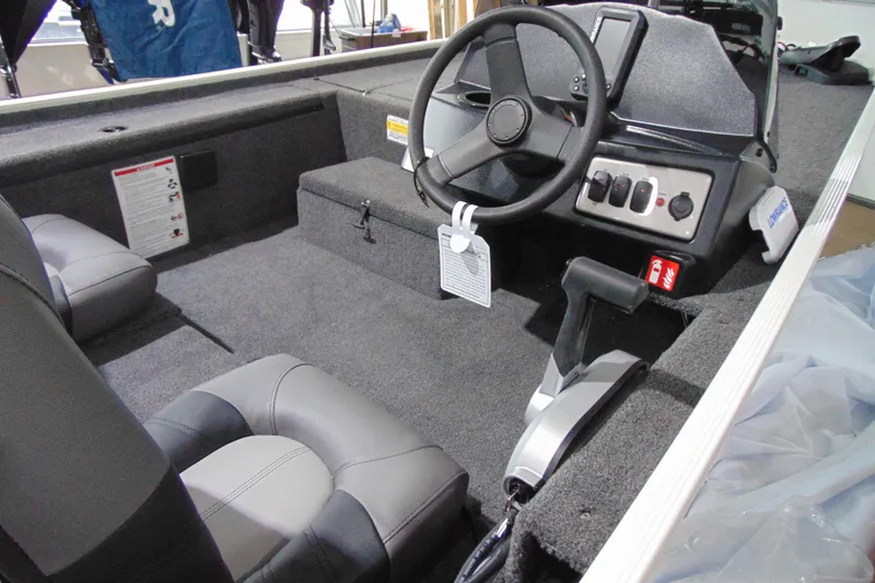 Slide: The Image of 2026 Crestliner 1600 Storm boat interior with steering wheel and control panel. - 9