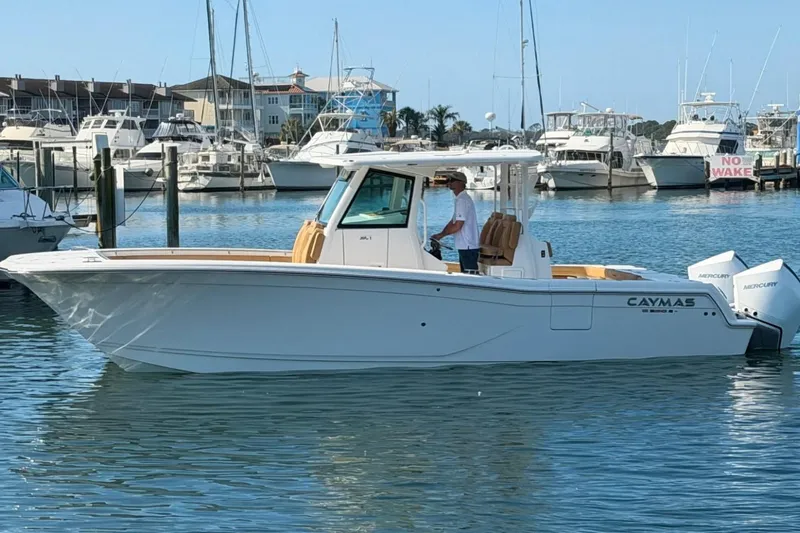 The Image of 2026 Caymas 30 CT boat in marina, featuring dual Mercury engines. - 0